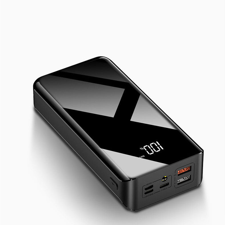 Powerbank z wyświetlaczem LCD obok telefonu